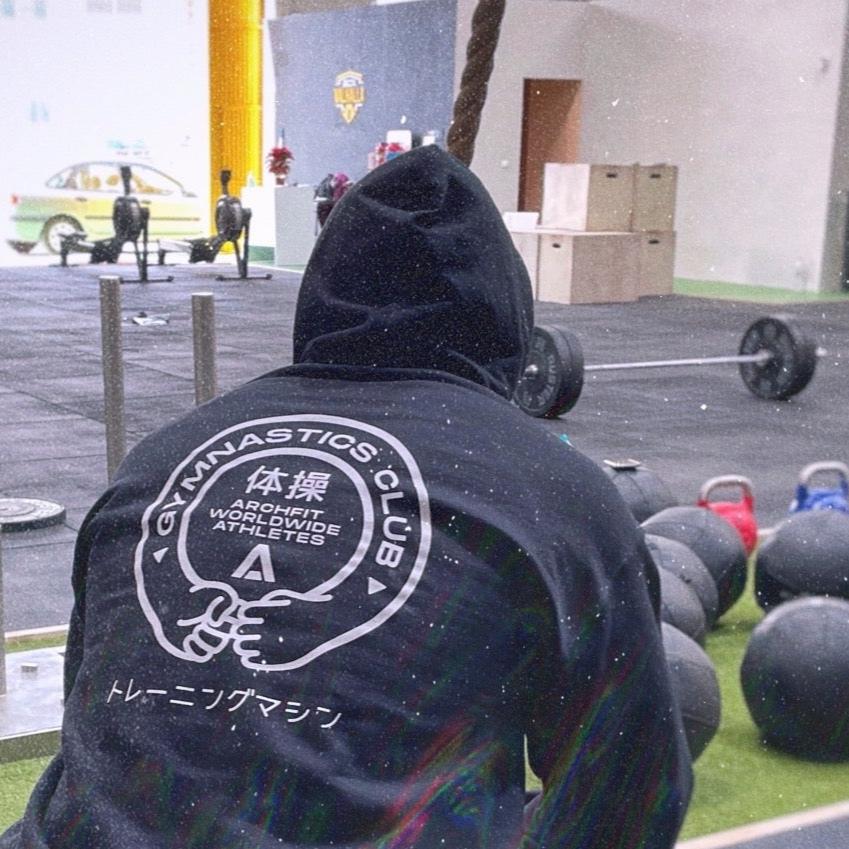 Sudadera con capucha unisex 'GYMNASTICS CLUB' - negro